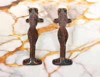Jaguar-shaped brass door handles underside with mounting plates and animal-shaped grip