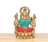 Rear view of Lakshmi brass idol with ornate halo and multicolor robe panels