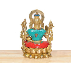 Rear view of Lakshmi brass idol with ornate halo and multicolor robe panels