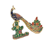 Brass peacock sculpture side view with green star-shaped base and colorful gems
