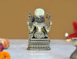 Rear view of brass Lakshmi Narasimha statue with patterned back and ornate base