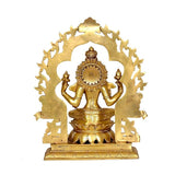 Rear view of gold-tone Lakshmi statue with circular halo and seated lotus base