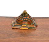 Brass Shri Yantra pyramid, front side view with rectangular base and corner motifs