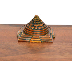 Brass Shri Yantra pyramid, front side view with rectangular base and corner motifs