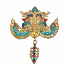 Brass Kirtimukha wall hanging with gold deity face, turquoise arms, and hanging hook