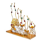 Metal reclining Buddha showpiece on gold base with lotus-shaped candle cups and red/green stems