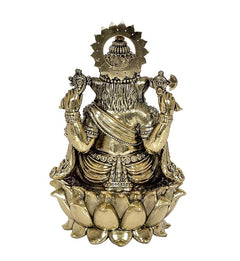 Back view brass Ganpati idol with decorative halo and lotus-like base