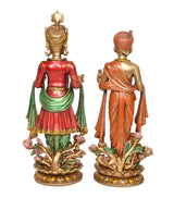 Resin swami idols from the back, orange turban and crown robes, ornate floral bases