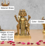 Brass Trimurti idol, golden finish, seated figure with raised hands, 4.5 in