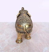 Gold brass elephant figurine with ornate backplate and decorative front legs, 4 in
