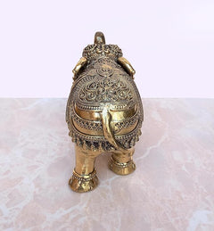 Gold brass elephant figurine with ornate backplate and decorative front legs, 4 in