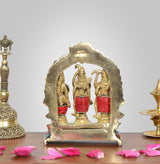 Brass Darbar idol from behind, arched backplate with three figures in relief