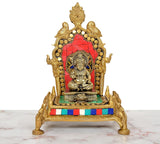 Gold Ganesha idol on red back panel pooja chowki, brass base, multicolor border