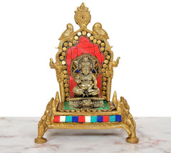 Gold Ganesha idol on red back panel pooja chowki, brass base, multicolor border