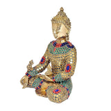 Brass Buddha idol cross-legged with raised left hand, colorful enamel stone mosaic