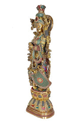 Brass Radha statue, side view with arched halo and colorful embroidered outfit