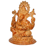 Brass Ganesha statue, three-quarter view with ornate halo and patterned garments