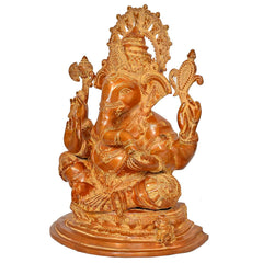 Brass Ganesha statue, three-quarter view with ornate halo and patterned garments