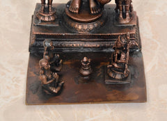 Copper idol base with engraved platform and four small seated attendants