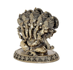 Brass Panchmukhi Ganesha idol from side view, engraved faces and patterned base
