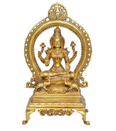 Golden brass Lakshmi statue, seated four hands with arched halo and base