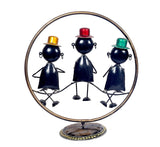 Iron musical men showpiece with dark blue figures, tall hats in red, yellow, green