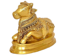 Brass Nandi cow statue idol angled view, ornate engravings and rounded hooves
