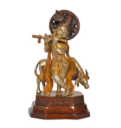Brass Lord Krishna with cow, flute in hand, facing front, decorative halo and base