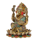 Brass Ganpati statue on lotus base, profile view with colorful jewelry and ornaments