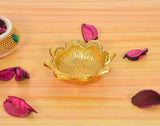 Gold lotus metal oil diya lamp with lit flame, embossed petal bowl