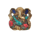 Small brass Ganesha statue, blue pendant-like ears, turquoise and red jeweled chest decor