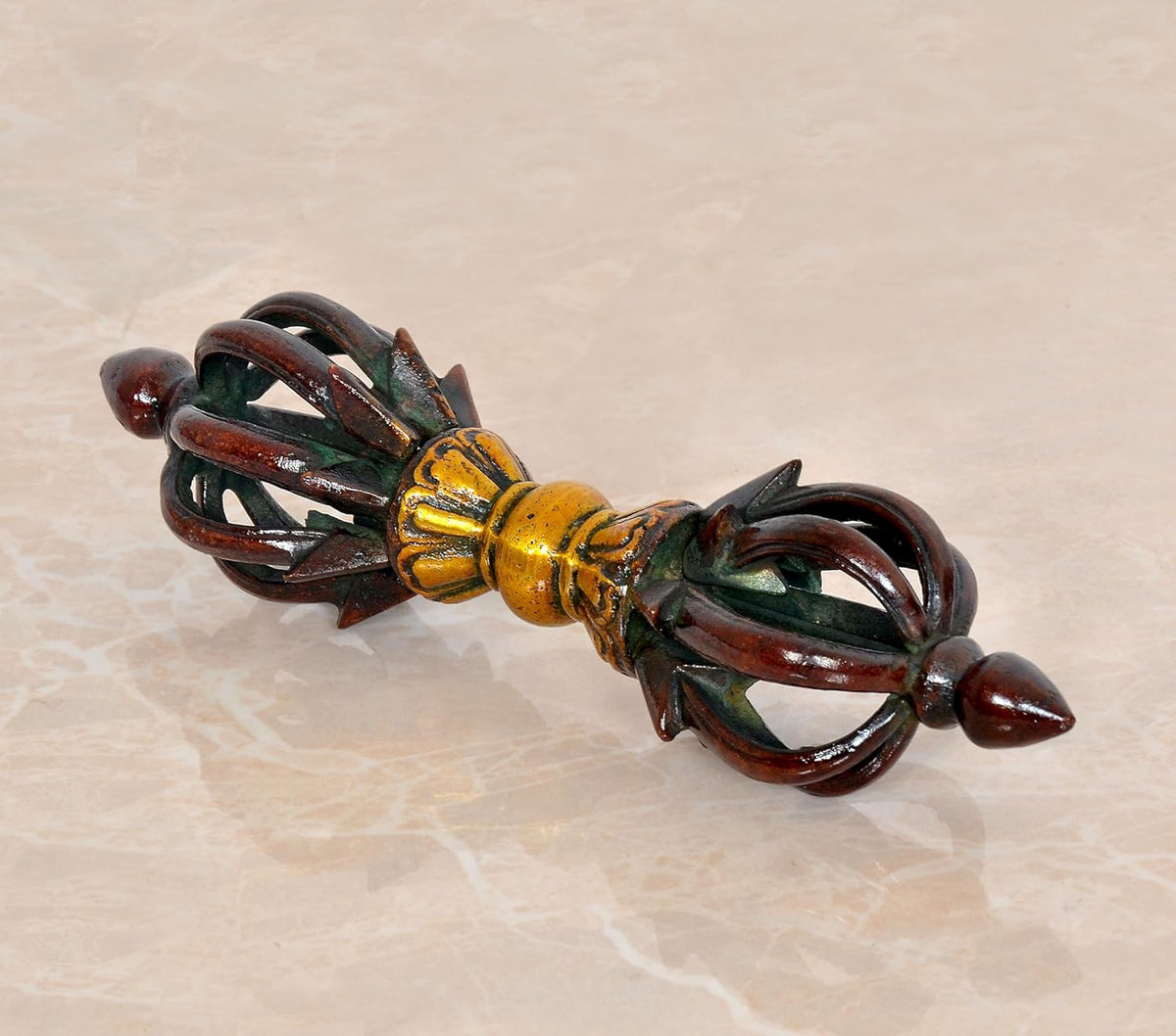Brass small eight-pronged dorje with dark brown handles and gold center details