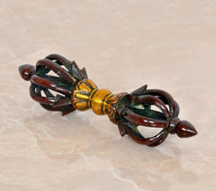 Brass small eight-pronged dorje with dark brown handles and gold center details