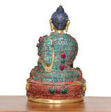 Messing-Buddha-Rückenansicht im Meditationssitz, türkis/rot Muster, dunkler Schopf