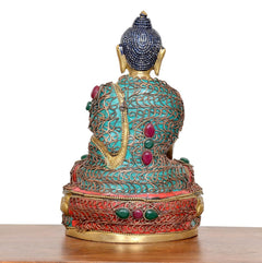 Messing-Buddha-Rückenansicht im Meditationssitz, türkis/rot Muster, dunkler Schopf