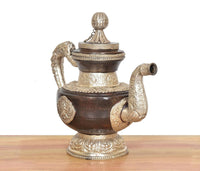 Brass Himalayan teapot with rounded lid finial, curled spouts, embossed oval motifs