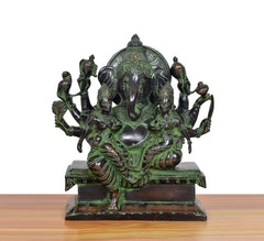 Brass Ganesha idol with Riddhi and Siddhi figures, seated posture, green-bronze finish