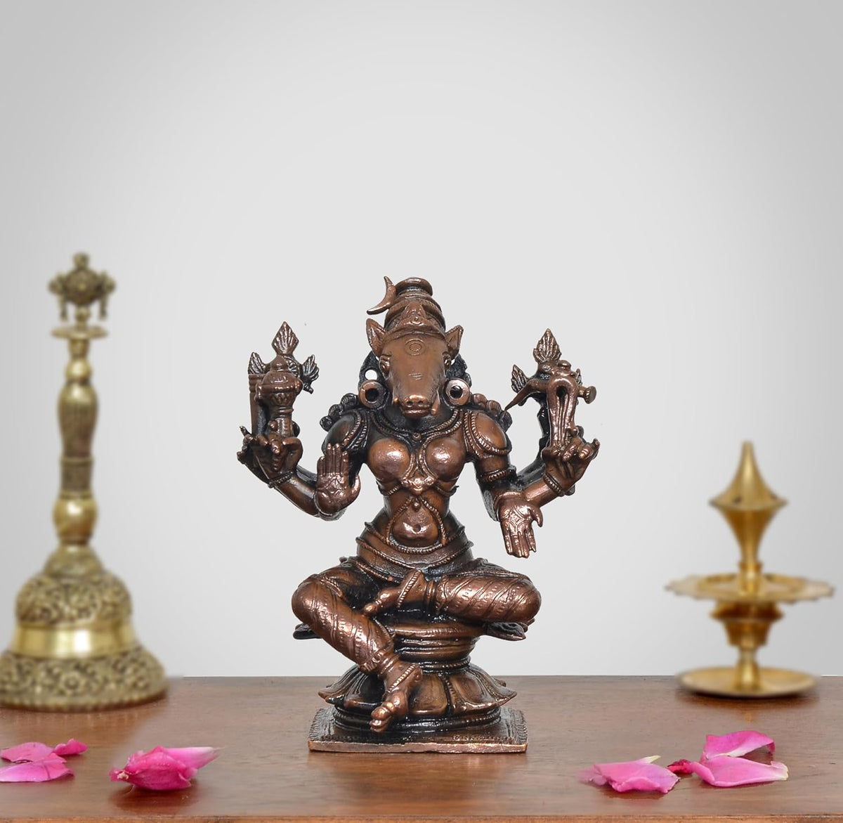 Copper goddess Varahi figurine, eight-armed seated pose, bronze-copper finish