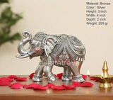 Silver elephant figurine, 3-inch height, raised tail and trunk, ornate side view.