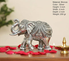 Silver elephant figurine, 3-inch height, raised tail and trunk, ornate side view.