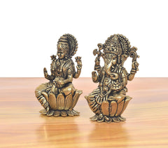 Side view of bronze Lakshmi and Ganesha mini statues with detailed lotus-seat forms.