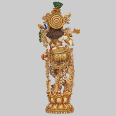 Back-view Krishna flute-playing idol with circular halo and ornate gold armor