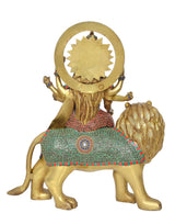 Brass Durga Maa on lion, back view with circular halo, patterned skirt and jewelry