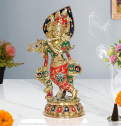 Brass Krishna playing flute idol statue with blue halo, red green dress, multicolor details.
