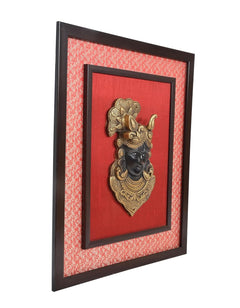 Side view of framed Shreenath ji brass face idol wall hanging with textured border