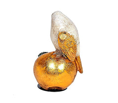 Polyresin bird paperweight figurine, golden-orange sphere base and white head