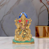 Brass Lord Ganesha idol statue with blue crown, multicolored jewelry, seated on base