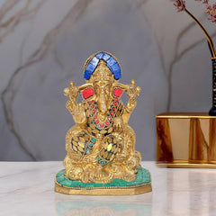 Brass Lord Ganesha idol statue with blue crown, multicolored jewelry, seated on base