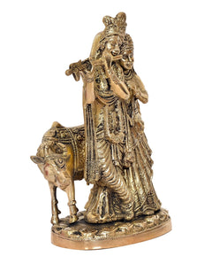 Brass Radha-Krishna idol with cow, close side view, crowned Radha and Krishna figures