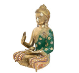Side view of brass Buddha idol seated, Abhaya mudra gesture, green robe with gold motifs